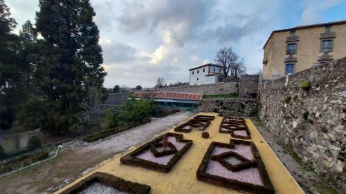 a stone wall with a bunch of plants in a yard at La Covatilla III in La Hoya