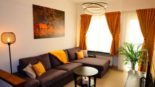 a living room with a couch and a window at La Tanière des Loups in Herbeumont