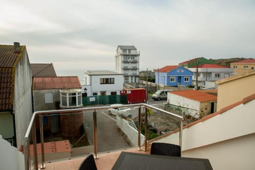 a view of a city from a balcony at Apartamentos turisticos HAZ AMIGO in Muxia