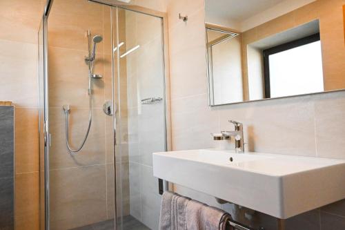 a bathroom with a sink and a shower at Garni Meinrad in Ora/Auer