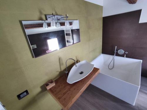 a bathroom with a white sink and a mirror at Veranda Vista Mare in Syracuse