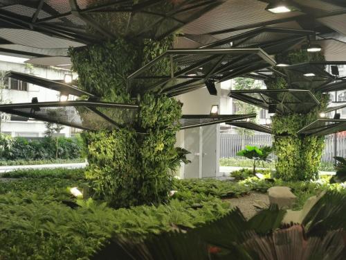a building with a green wall with plants at Continew Residence by HomeBrickz in Kuala Lumpur