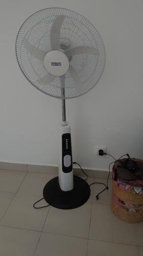 a white fan sitting on top of a floor at Case traditionnelle diola au bord de l'océan in Cap Skirring