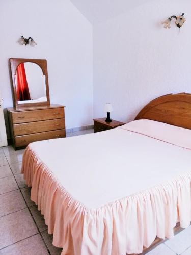 a bedroom with a white bed and a mirror at Résidence Le Dattier, 3 bedrooms apartment, Flic en Flac in Flic-en-Flac