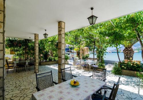 a table with a bowl of fruit on it on a patio at House Lopin in Žuljana