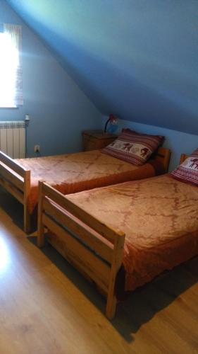 two beds in a room with a attic at Organistowka in Bircza
