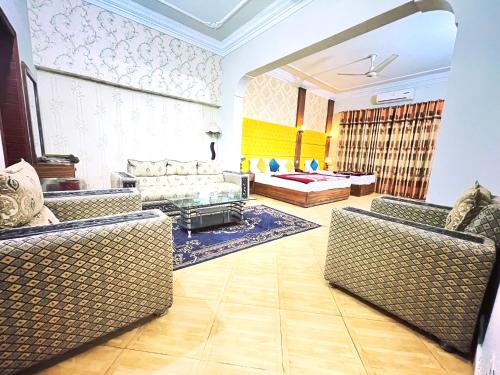 a living room with two couches and a couch at Hotel Serena Palace in Multan