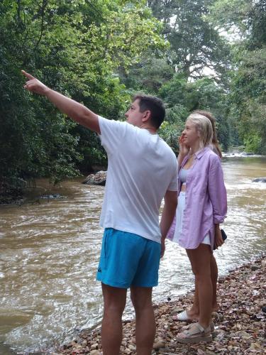 a man and a girl standing next to a river at Ceylan Star Guest Inn in Wellawaya