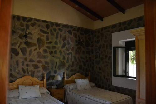 Postel nebo postele na pokoji v ubytování Casas Rurales Los Llanos