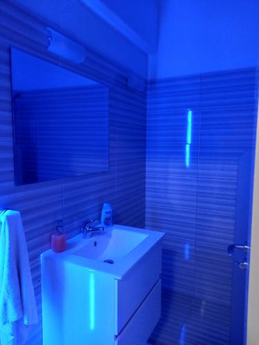 a bathroom with a white sink and a mirror at Old Town studio apartment in Larnaka