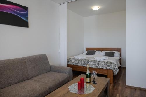 a living room with a couch and a bed at SGL apartment Liptovska with free parking in Trenčín