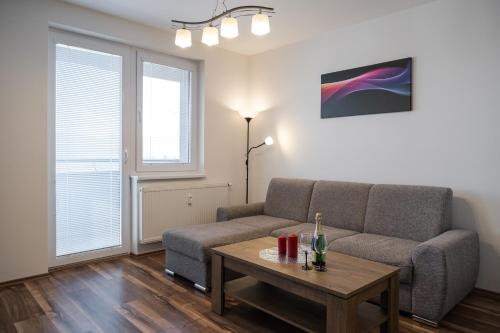 a living room with a couch and a table at SGL apartment Liptovska with free parking in Trenčín