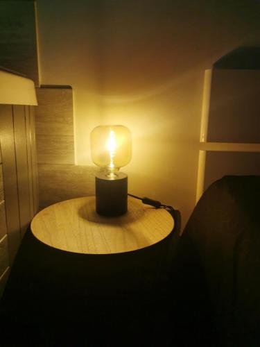a lamp sitting on a table in a room at Jacuhomespa13 in Vitrolles