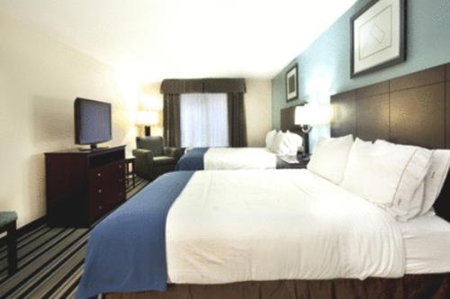 a hotel room with two beds and a television at Holiday Inn Express Hotel & Suites Baton Rouge -Port Allen by IHG in Port Allen