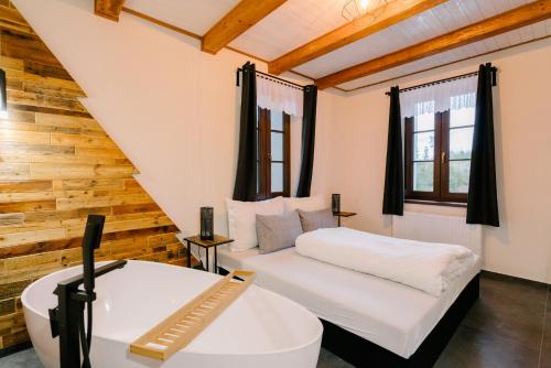 a bedroom with a white bed and a desk at Kamenná stráň in Metylovice