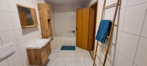 a bathroom with a toilet and a sink and a tub at VIA MALA Apartment in Kirchensittenbach