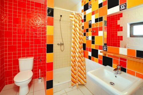 a colorful bathroom with a toilet and a sink at Semi-detached houses, Sarbinowo in Sarbinowo