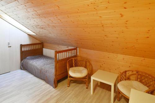 a bedroom with a bed and a table and chairs at Terraced House in Grzybowo near Beach in Grzybowo