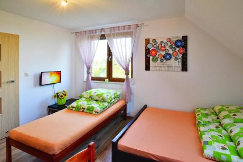 a small room with two beds and a window at Apartments, Sarbinowo in Sarbinowo