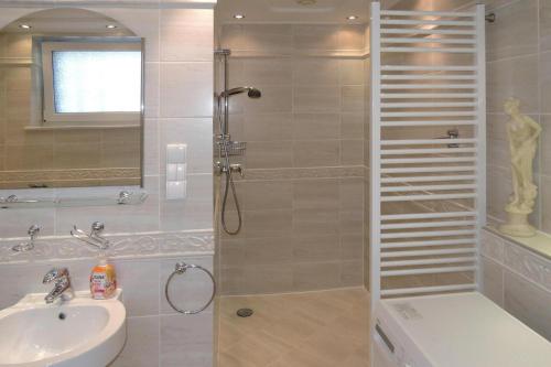 a bathroom with a shower and a sink at Semi-detached house, Miedzyzdroje in Międzyzdroje