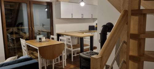 a small kitchen with a table and chairs in a room at Leśniczówka Kalina in Wetlina