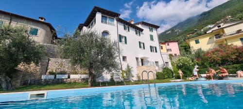 une maison et une piscine en face d'un bâtiment dans l'établissement Villa Borgo Borago, à Brenzone