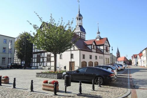 a black car parked in front of a building at Holiday home for 10 Person in Nowe Warpno in Nowe Warpno