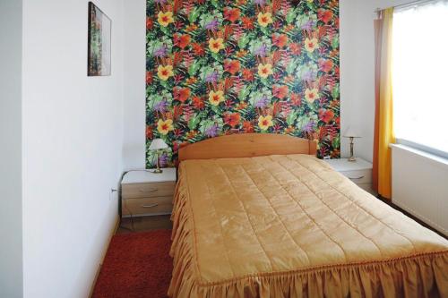 a bedroom with a bed with a floral wallpaper at Holiday home for 10 Person in Nowe Warpno in Nowe Warpno