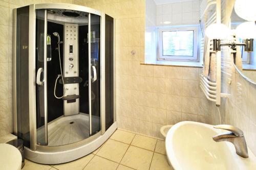 a bathroom with a shower and a sink at Comfortable house by the lake, Insko in Ińsko
