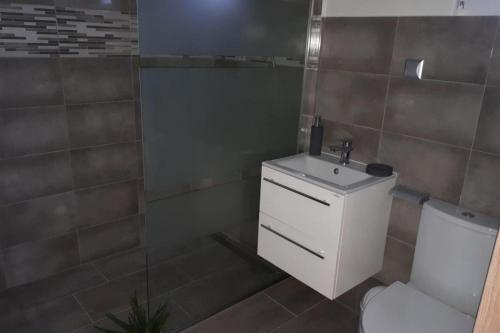 a bathroom with a white sink and a toilet at holiday home, Jezierzany in Jezierzany