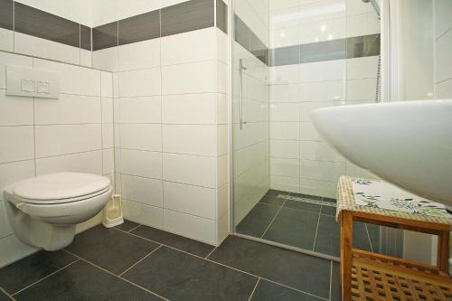 a bathroom with a toilet and a sink at Apartment lake view, Malchow in Malchow