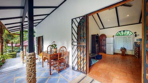 an open living room with a table and a kitchen at The Scarlet Villas in Ojochal