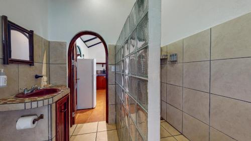 a bathroom with a sink and an arch doorway at The Scarlet Villas in Ojochal
