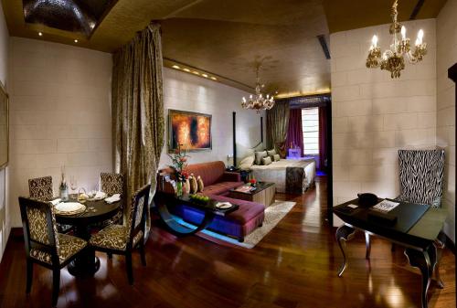 a living room with a couch and a table at Radisson Blu MBD Hotel Noida in Noida