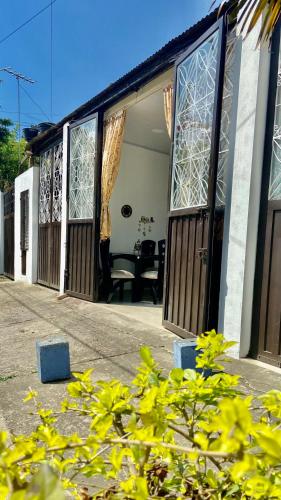 a house with windows and a patio with a table at Rincón de Kike in Villeta