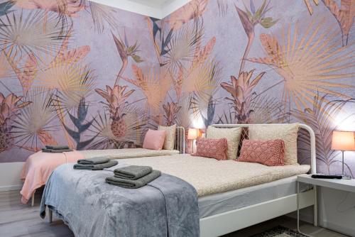 a bedroom with a bed with a pink flower wallpaper at Budapest Holidays Harmony in Budapest