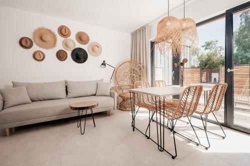 a living room with a couch and a table and chairs at AMORZELAS in Dębki