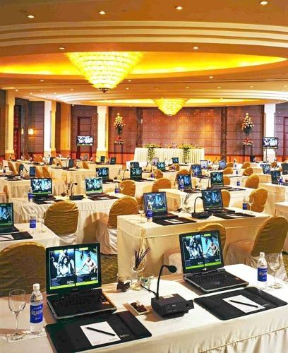 a large room filled with tables with laptops on them at Radisson Blu MBD Hotel Noida in Noida