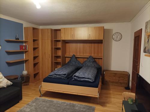 a bedroom with a bed with pillows on it at The Deer's Den in Garmisch-Partenkirchen