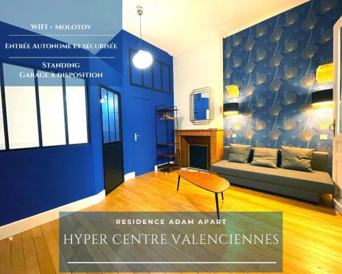 a living room with a couch and a table at Résidence Adam à part in Valenciennes