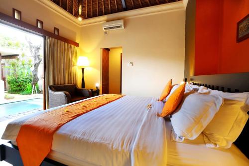 a bedroom with a large bed and a large window at The Bali Bliss Villa in Seminyak