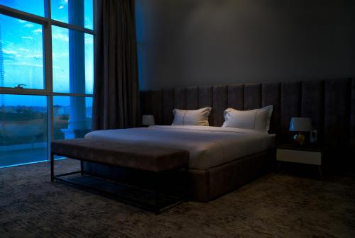 Cama o camas de una habitación en فندق راديانس جراند