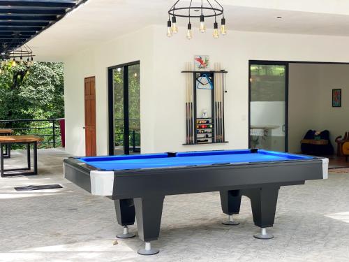 a pool table in the middle of a room at The Scarlet Villas in Ojochal