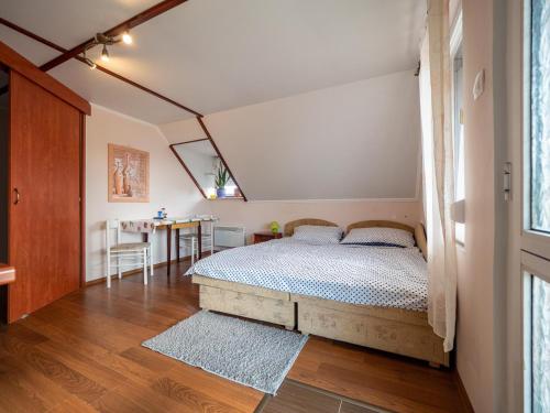 a bedroom with a bed in the middle of a room at Pipacsos Vendégházak in Kiskunmajsa