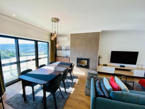 a living room with a dining table and a tv at Lovely apartment for family and group of friends in Póvoa de Santa Iria