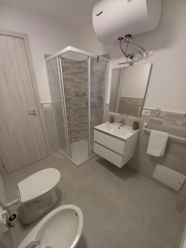 a bathroom with a toilet and a sink and a shower at Domus Genuensis in Genoa