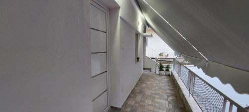 a hallway of a building with a door and a balcony at Angie's House Volos in Volos