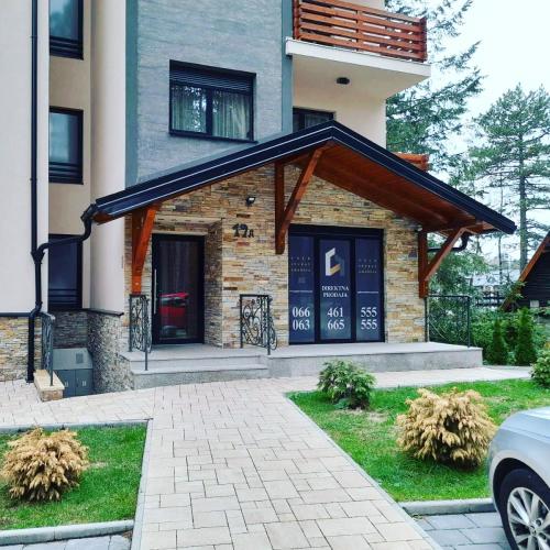 a building with awning on the front of it at Apartman Pineta in Zlatibor