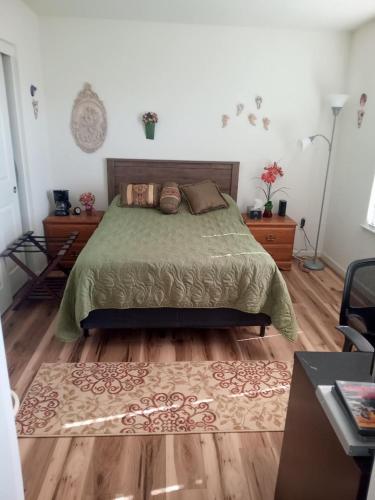 a bedroom with a bed and a wooden floor at Room in Campbell with Own Bthrm in Campbell