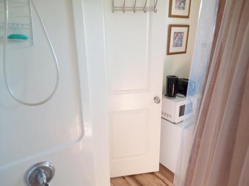 a bathroom with a white door and a sink at Room in Campbell with Own Bthrm in Campbell
